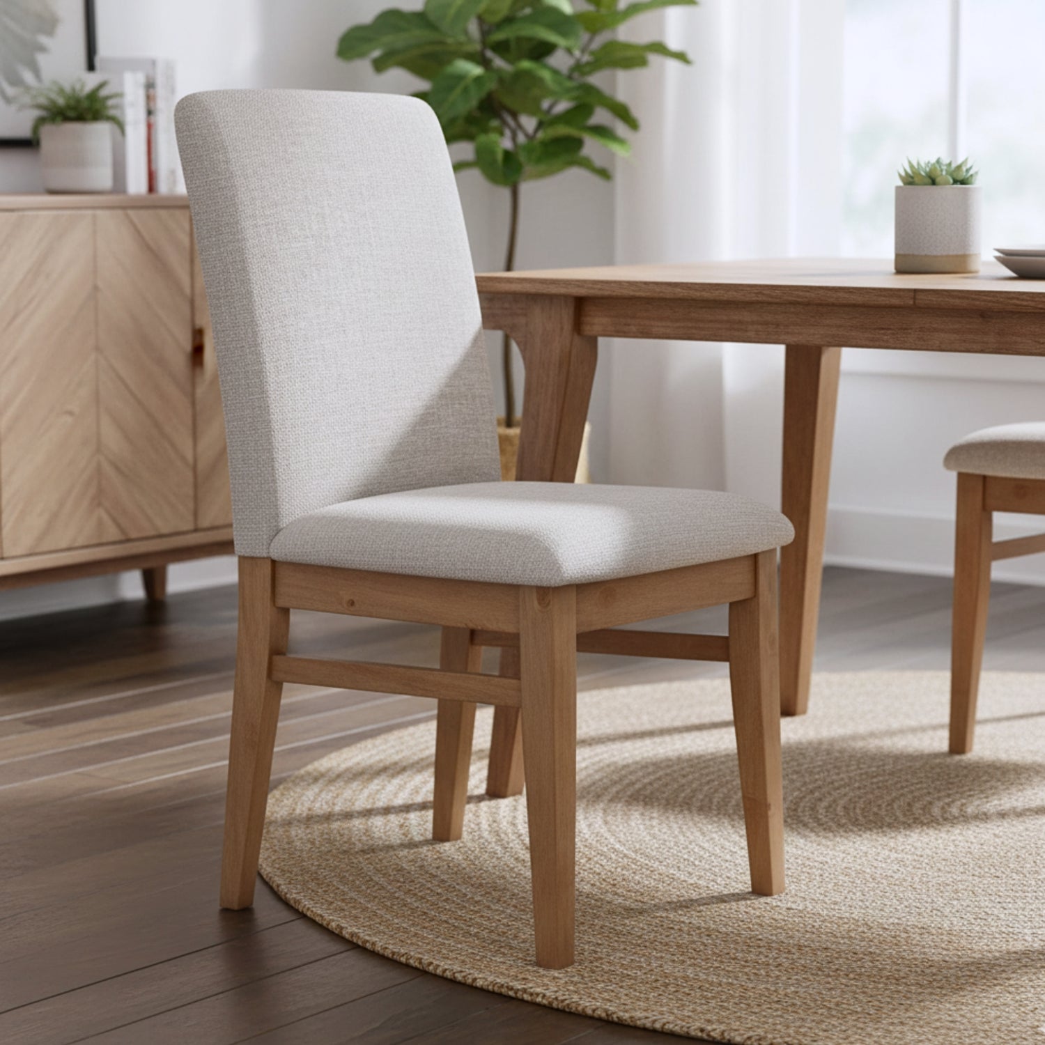 Dining room with wooden table and chairs, plants, and a cabinet.